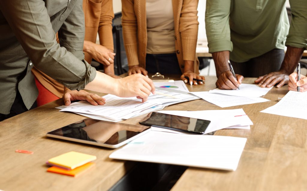 Photo of persons in a meeting discussing strategy