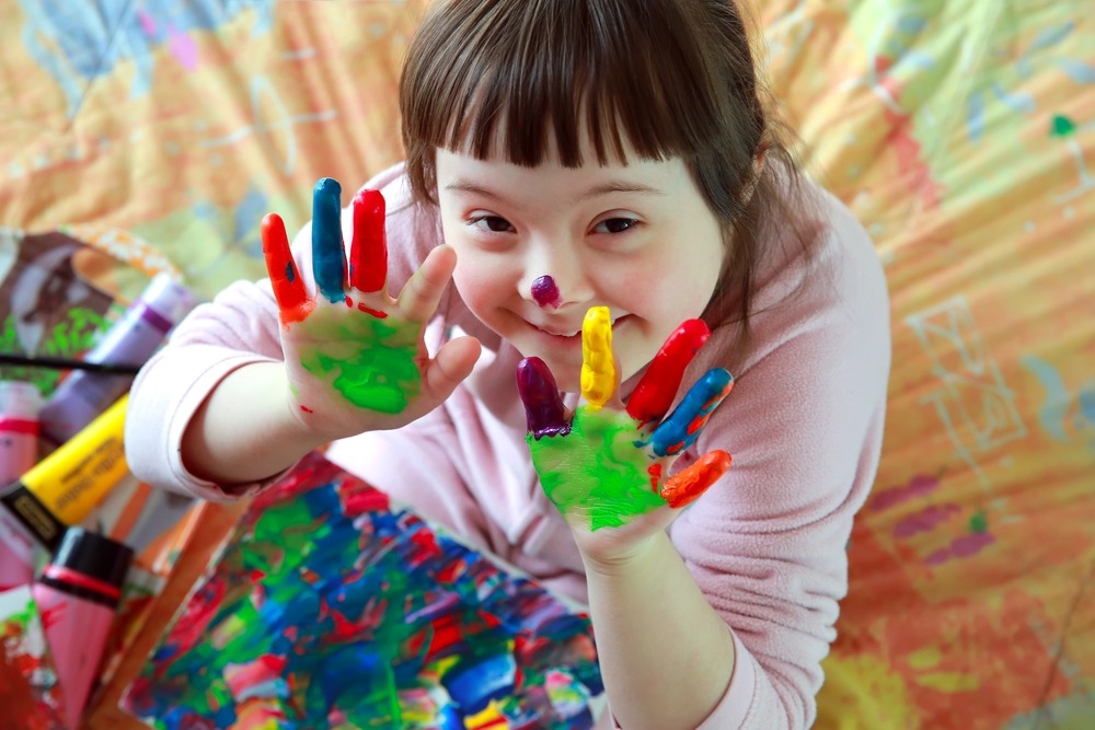 A Young child playing with finger paint